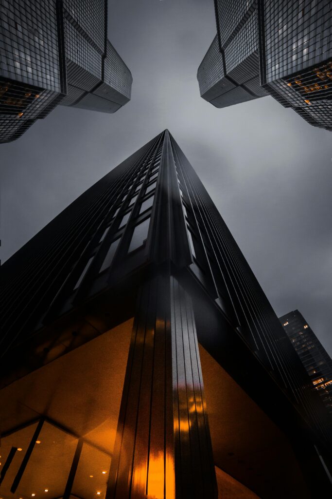 pexels photo 1707823 1707823 A low angle view of skyscrapers reaching into a moody night sky, showcasing modern architecture.
