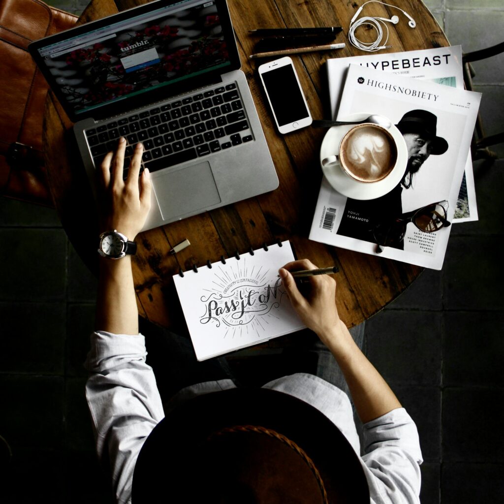 pexels photo 57690 57690 Top view of a creative workspace with laptop, coffee, and hand lettering for design inspiration.